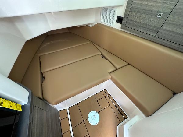 Slide: The Image of 2024 Aviara AV36 cabin interior with tan cushions and wood accents. - 10
