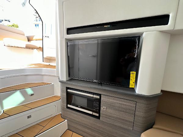 Slide: The Image of 2024 Aviara AV36 interior with TV, microwave, and stairs. - 11