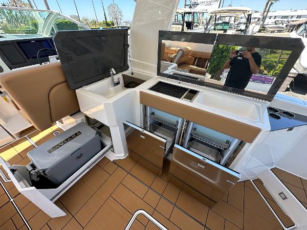 Slide: The Image of 2024 Aviara AV36 boat interior with kitchen amenities and storage compartments. - 4