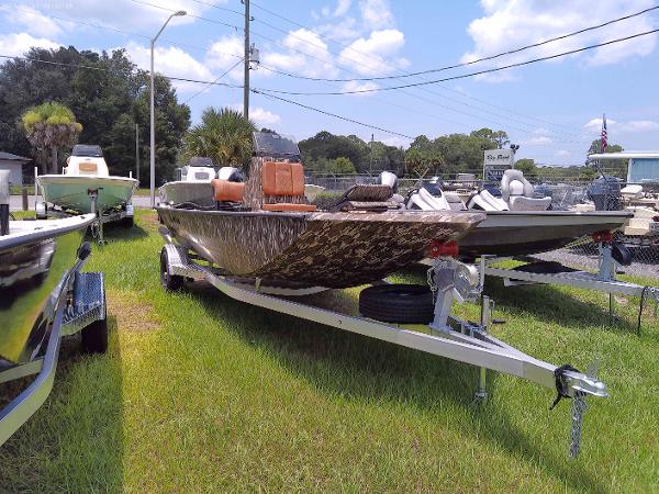 Slide: The Image of 2023 Avid 18 Rogue boat on trailer in outdoor lot. - 1