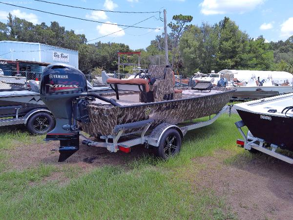 Slide: The Image of 2023 Avid 18 Rogue boat with Yamaha motor on trailer in outdoor lot. - 2