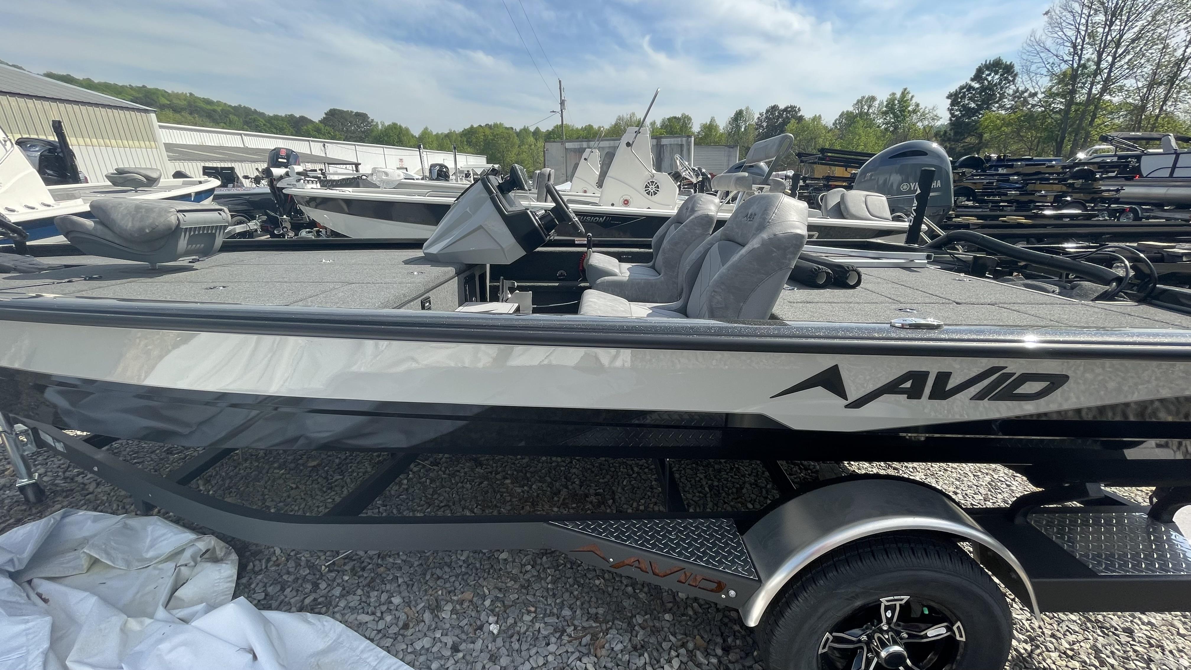 Slide: The Image of 2023 Avid 19XB fishing boat on trailer, parked outdoors. - 11