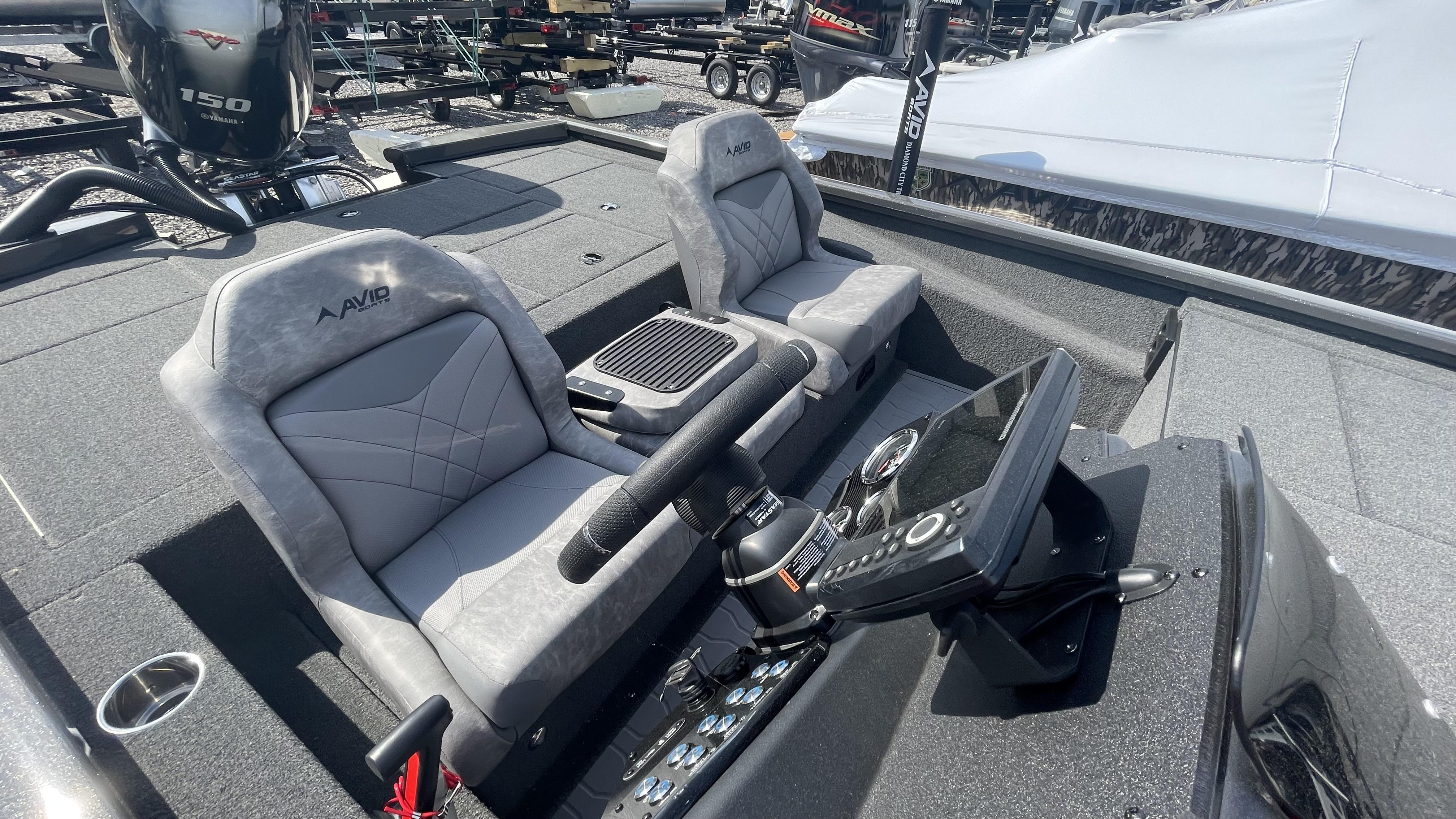 Slide: The Image of 2023 Avid 19XB boat interior with dual seats and steering console. - 11
