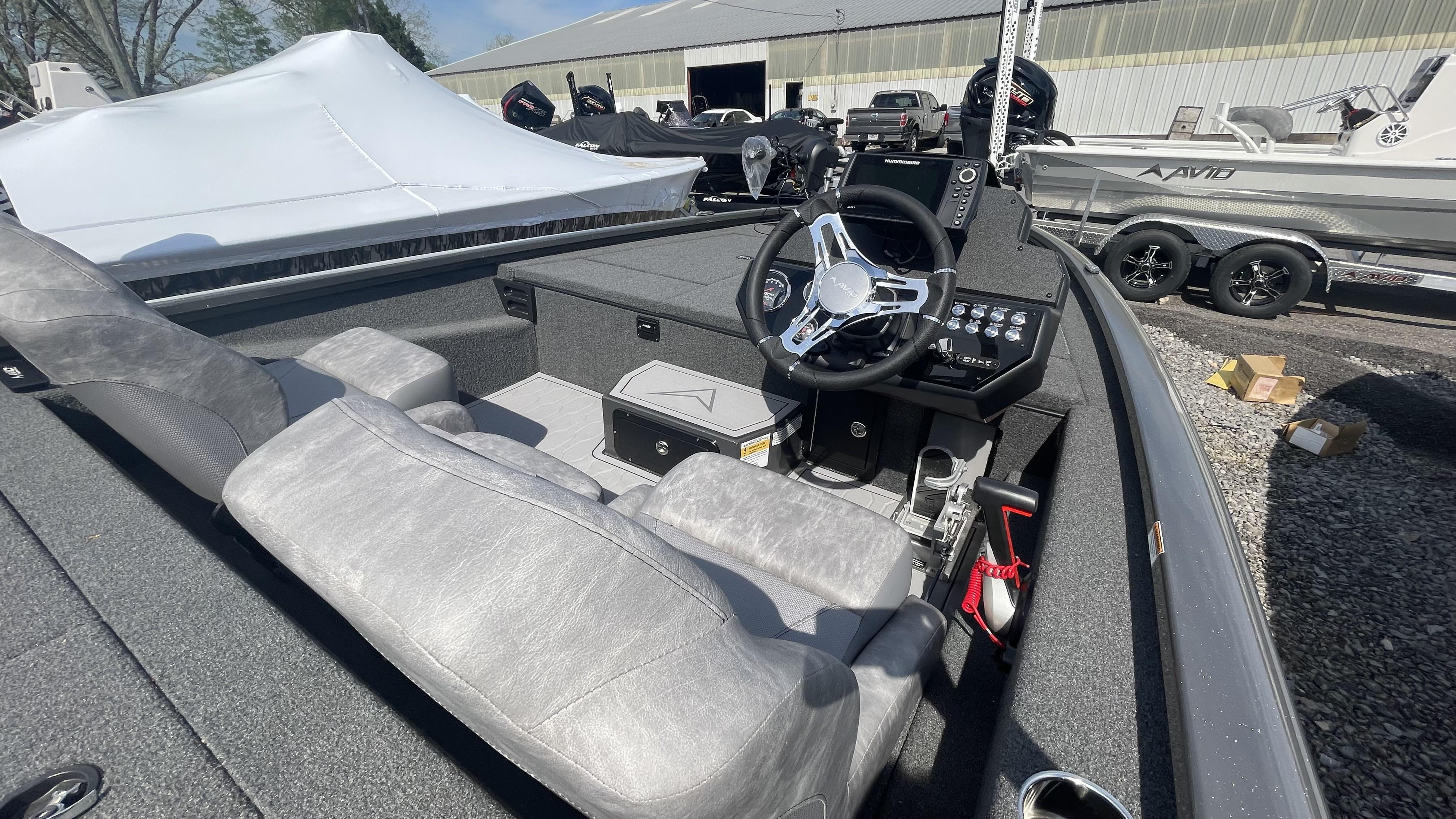 Slide: The Image of 2023 Avid 19XB boat interior with steering wheel and control panel. - 12