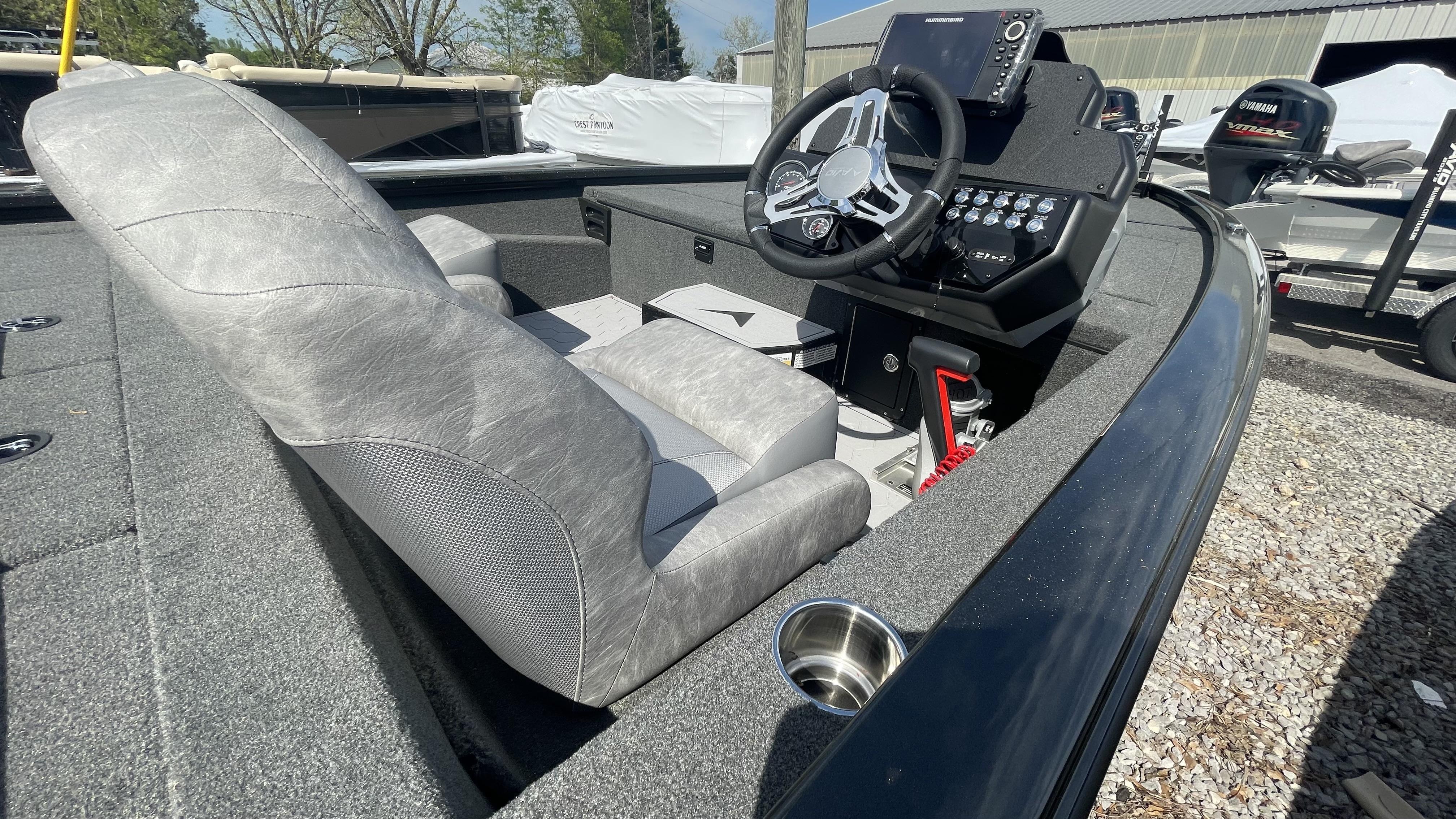 Slide: The Image of 2023 Avid 19XB boat interior with steering console and gray seating. - 15