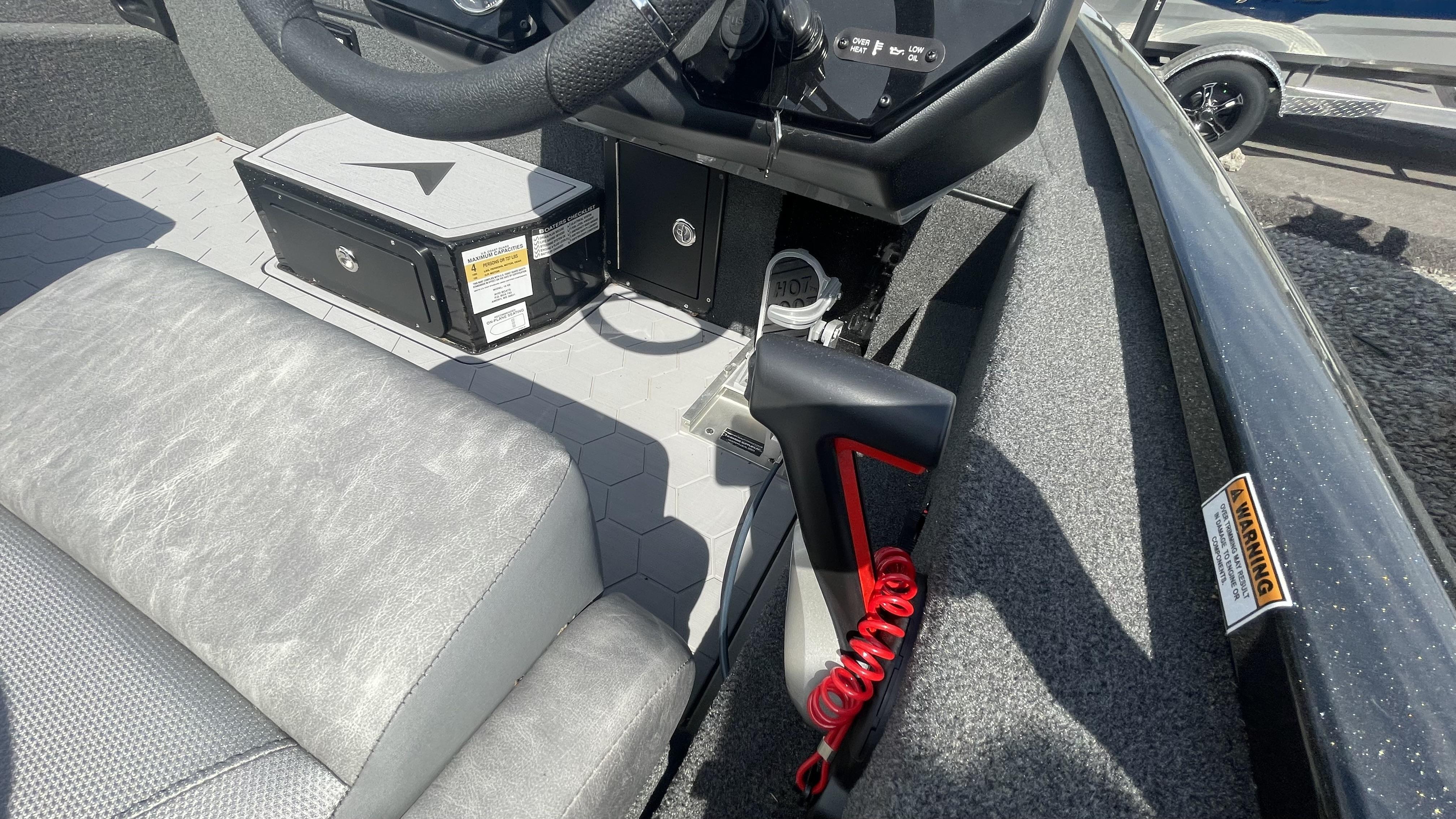 Slide: The Image of Interior of 2023 Avid 19XB boat showing steering wheel, seat, and control panel. - 16