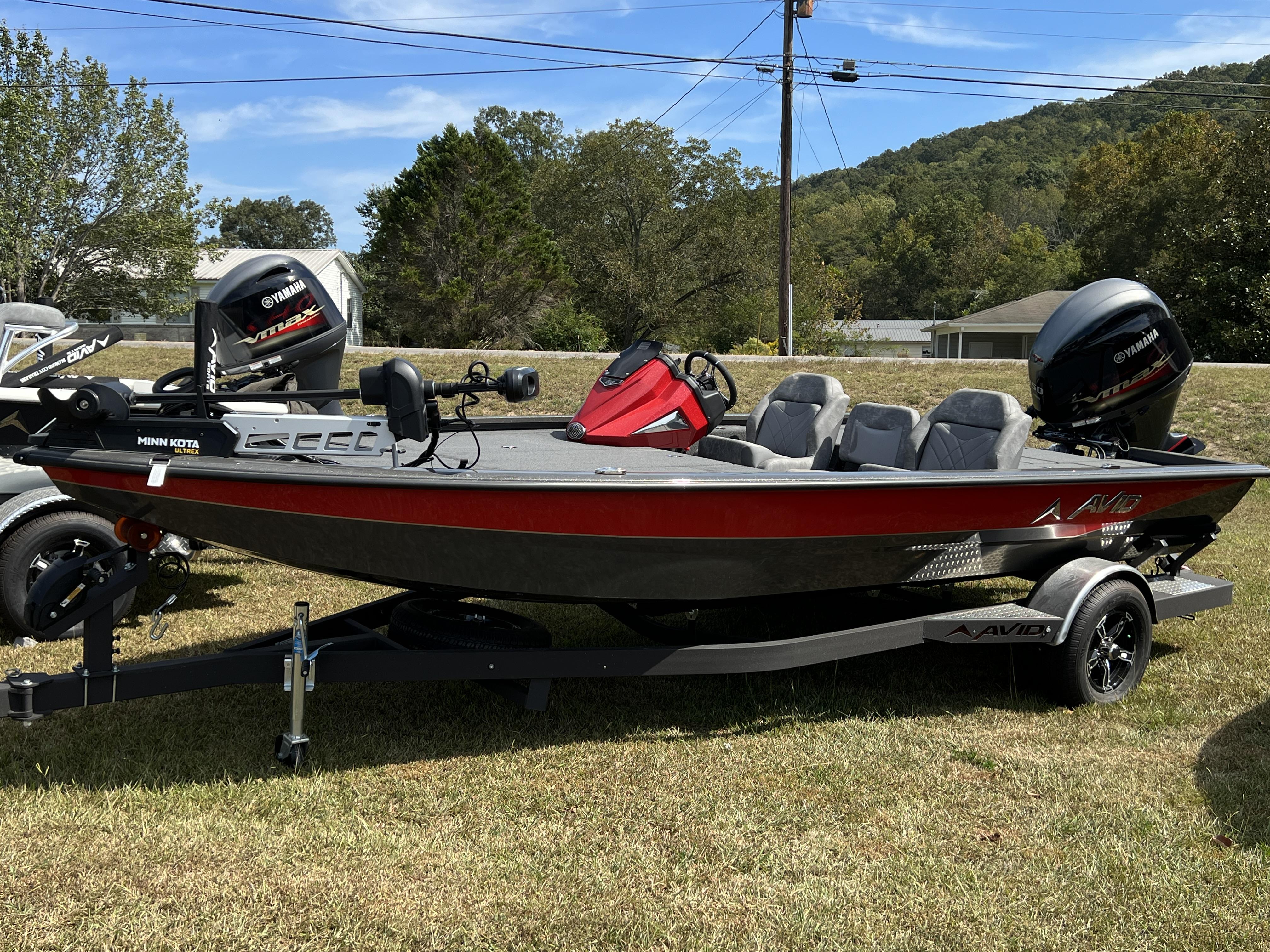 Slide: The Image of 2023 Avid 19XB fishing boat with Yamaha motor on trailer. - 19