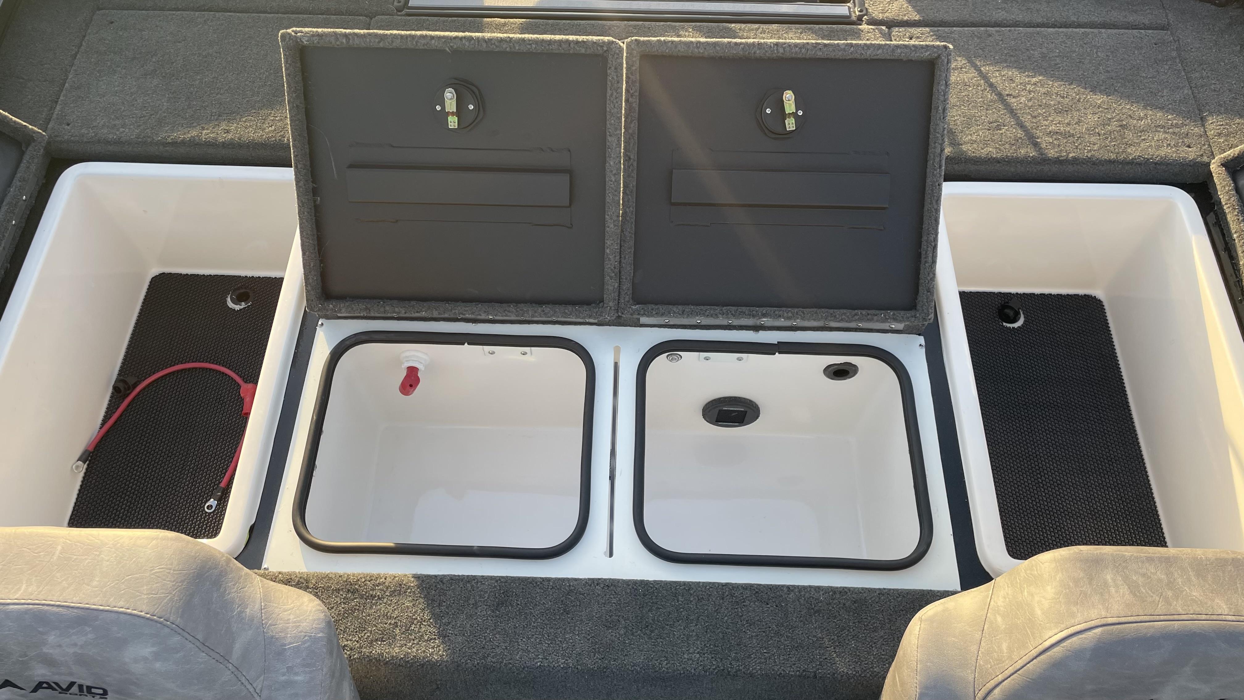 Slide: The Image of 2023 Avid 19XB boat storage compartments with open lids and interior view. - 2