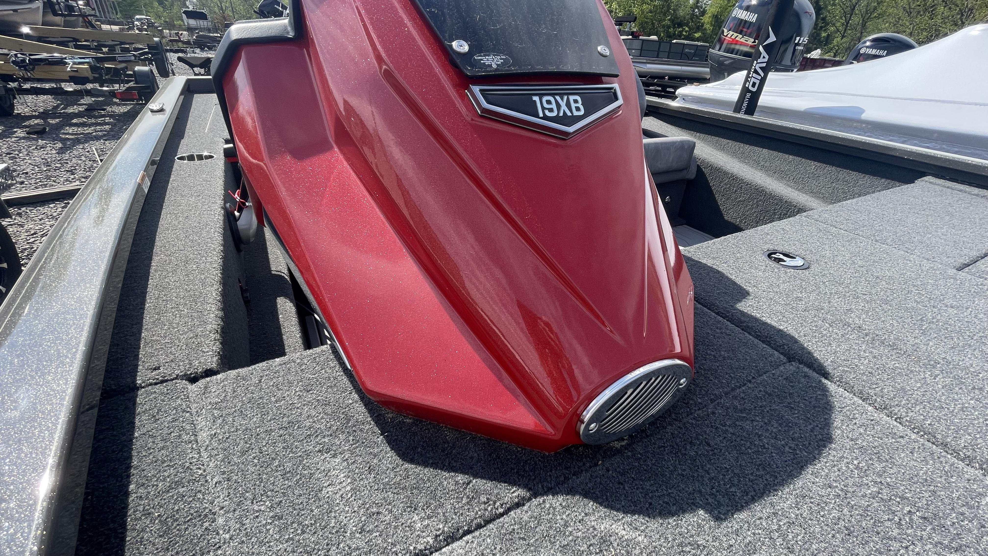 Slide: The Image of 2023 Avid 19XB boat with red hull and carpeted deck. - 5