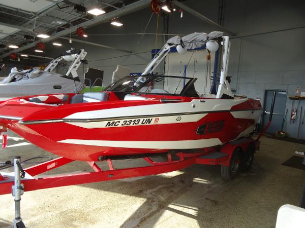 Slide: The Image of 2021 Axis A20 red and white boat on trailer in indoor storage. - 1