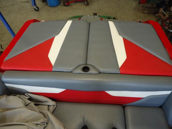Slide: The Image of 2021 Axis A20 boat rear seating with red, gray, and white upholstery. - 2