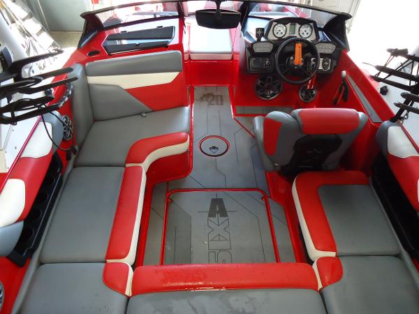 Slide: The Image of 2021 Axis A20 boat interior with red and gray seating, dashboard, and controls. - 3