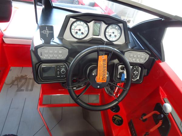 Slide: The Image of 2021 Axis A20 boat dashboard with steering wheel, gauges, and control panel. - 6