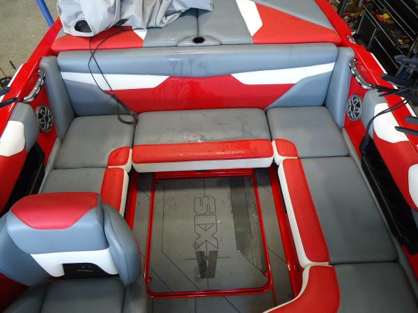 Slide: The Image of 2021 Axis A20 boat interior with red, gray, and white seating. - 9