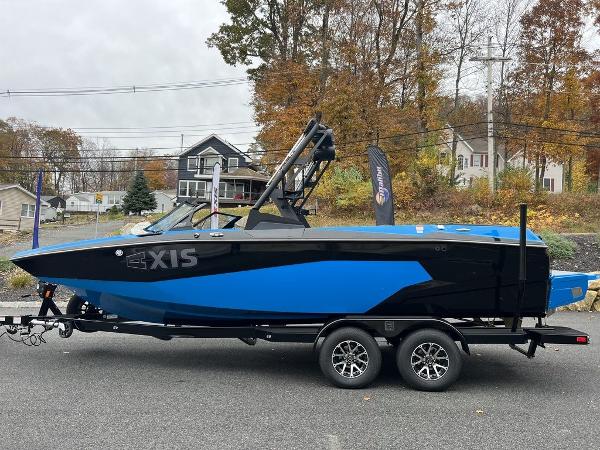 Slide: The Image of 2024 Axis A225 boat in blue and black on a trailer. - 11