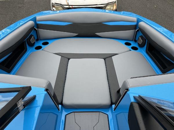 Slide: The Image of 2024 Axis A225 boat interior with blue and gray seating. - 13