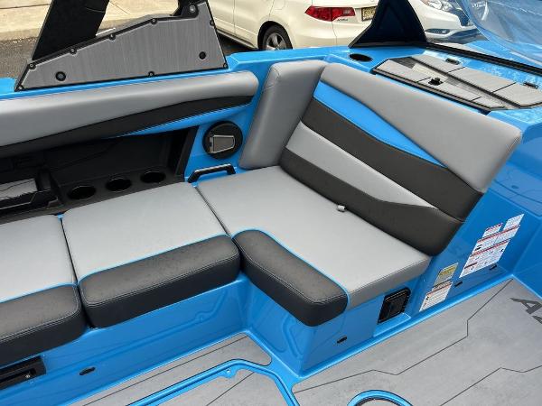 Slide: The Image of 2024 Axis A225 boat interior with blue and gray seating. - 2
