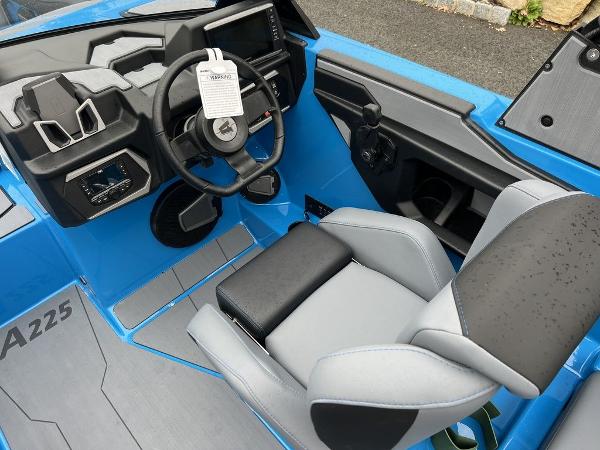 Slide: The Image of 2024 Axis A225 boat interior with steering wheel and captain's seat. - 4
