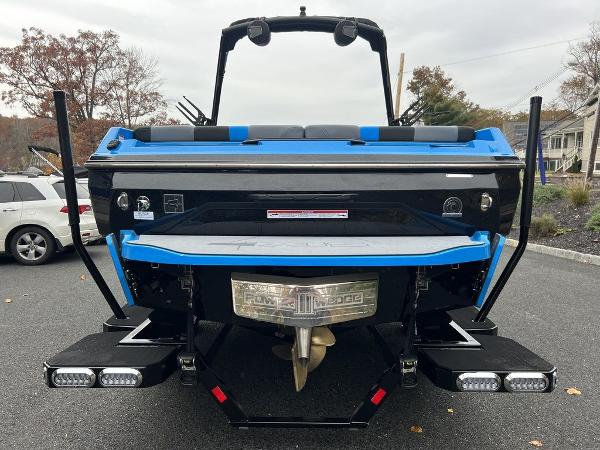 Slide: The Image of 2024 Axis A225 boat rear view with blue and black detailing. - 6