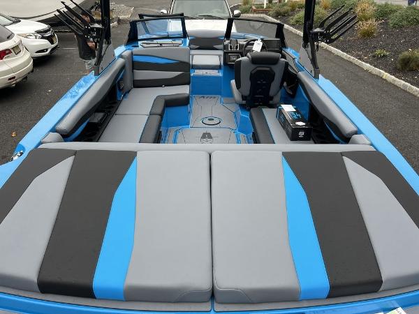 Slide: The Image of 2024 Axis A225 boat interior with blue and gray seating. - 8