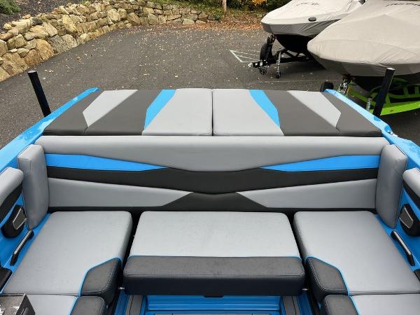 Slide: The Image of 2024 Axis A225 boat interior with blue and gray seating. - 9