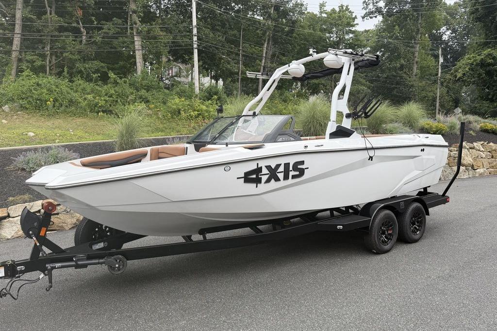 Slide: The Image of 2026 Axis A225 boat on trailer, parked outdoors with lush greenery background. - 3