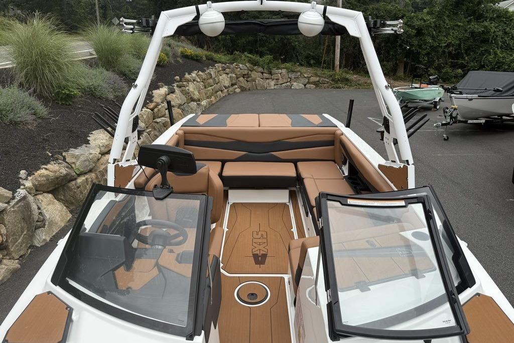 Slide: The Image of 2026 Axis A225 boat interior with tan seating and modern dashboard design. - 9