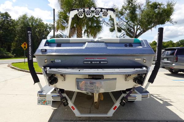 Slide: The Image of 2020 Axis T22 boat rear view with speakers and palm trees in background. - 6