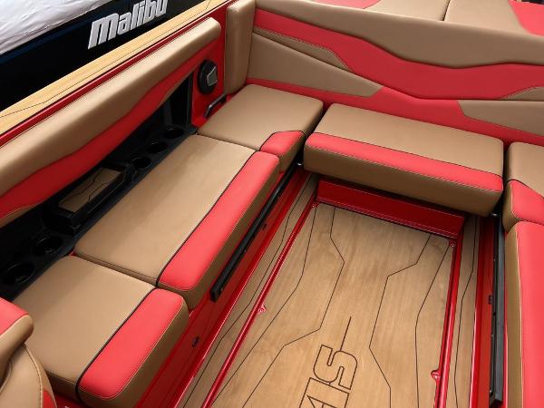 Slide: The Image of 2024 Axis T235 boat interior with red and tan seating and wood flooring. - 12