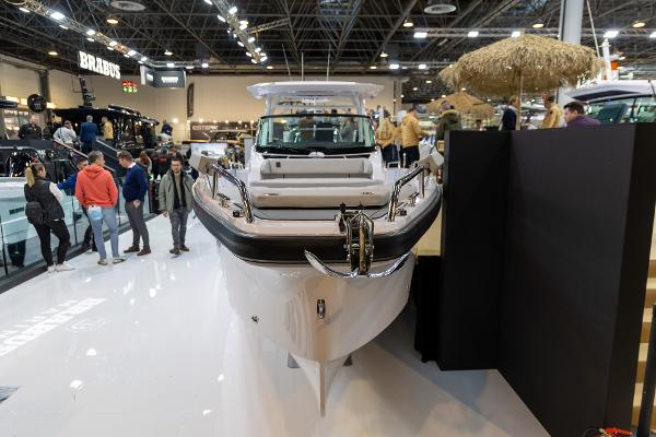 Slide: The Image of 2024 Axopar 29 Sun Top boat displayed at indoor exhibition. - 1
