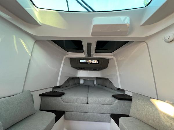 Slide: The Image of Interior cabin of 2023 Axopar 37 Sun-Top boat with skylight and grey seating. - 22