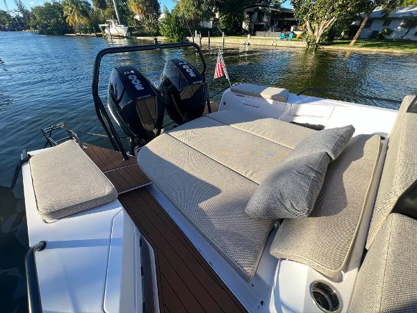 Slide: The Image of 2023 Axopar 37 Sun-Top boat with twin outboard engines and sunbathing area. - 43