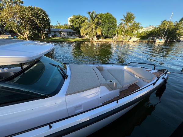 Slide: The Image of 2023 Axopar 37 Sun-Top boat docked near a tropical shoreline. - 9