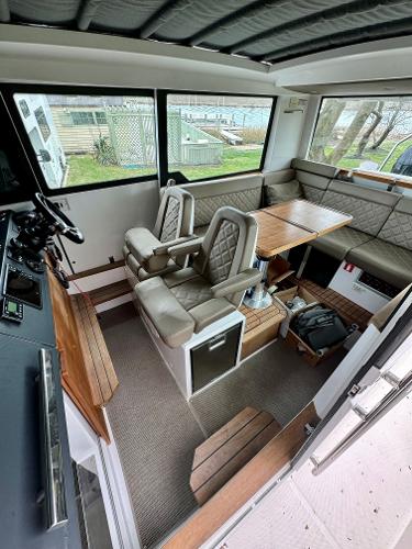 Slide: The Image of Interior of a 2018 Axopar 37XC Cross Cabin with seating and table. - 14
