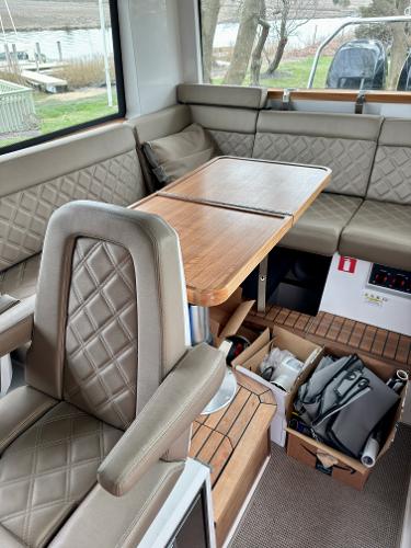 Slide: The Image of Interior of 2018 Axopar 37XC CROSS CABIN with leather seating and wooden table. - 15