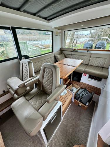 Slide: The Image of Interior of 2018 Axopar 37XC Cross Cabin with seating and dining area. - 16