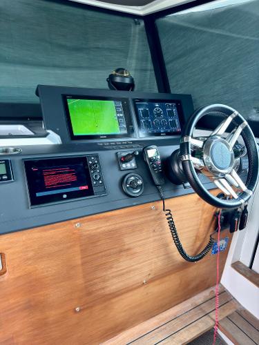 Slide: The Image of Axopar 37XC CROSS CABIN 2018 helm station with navigation equipment and steering wheel. - 21