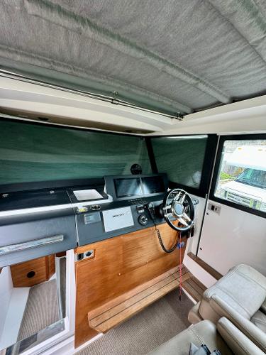 Slide: The Image of Interior helm of 2018 Axopar 37XC CROSS CABIN with modern controls and seating. - 25