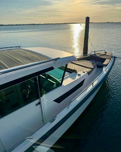 Slide: The Image of 2018 Axopar 37XC CROSS CABIN boat docked at sunset. - 4