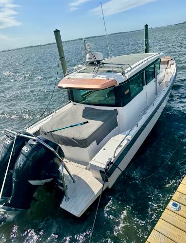 Slide: The Image of 2018 Axopar 37XC CROSS CABIN docked on a sunny day. - 6