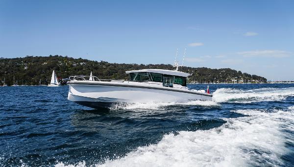 Slide: The Image of 2024 Axopar 37 XC Cross Cabin Wet Bar cruising on open water. - 1