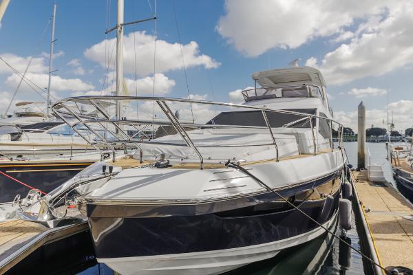 Slide: The Image of 2021 Azimut 60 Flybridge yacht docked at marina under blue sky. - 1