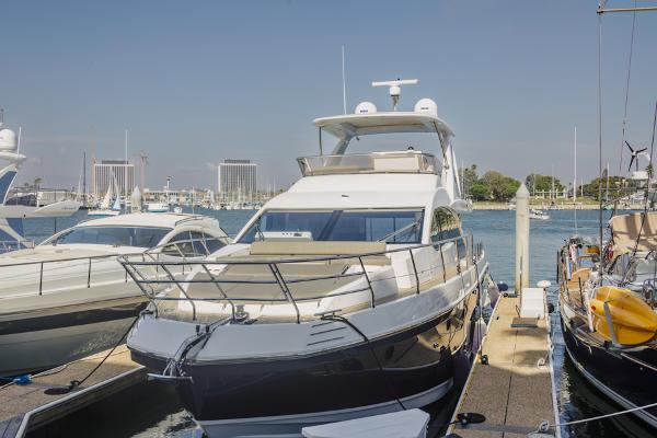 Slide: The Image of Azimut 60 Flybridge 2021 yacht docked at marina, clear sky background. - 10