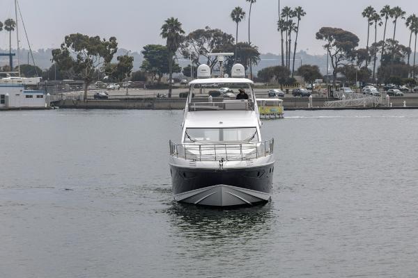 Slide: The Image of Azimut 60 Flybridge 2021 yacht cruising in a marina with palm trees in the background. - 11