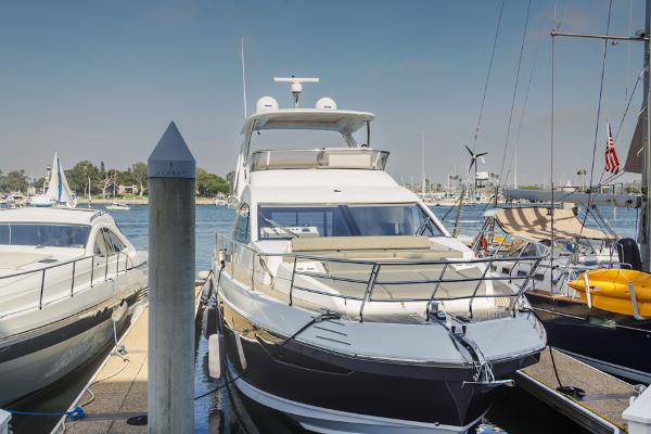 Slide: The Image of 2021 Azimut 60 Flybridge yacht docked at marina, sunny day. - 13