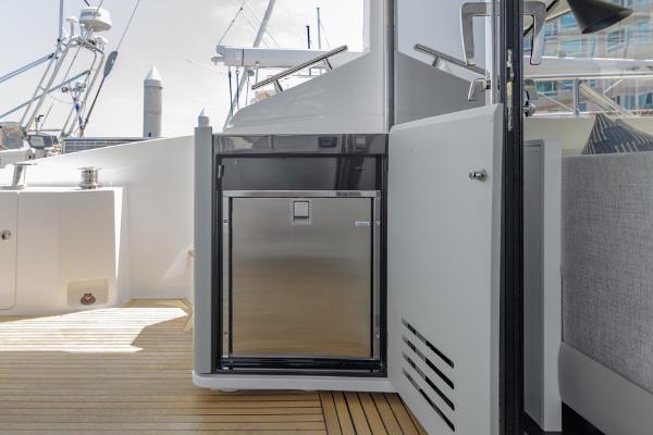 Slide: The Image of Azimut 60 Flybridge 2021 yacht deck with stainless steel fridge and wooden flooring. - 19