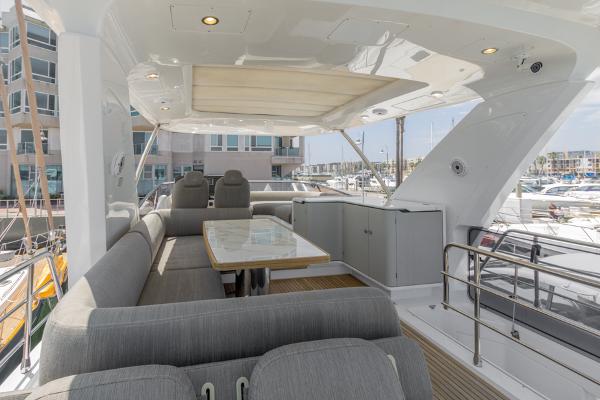 Slide: The Image of Azimut 60 Flybridge 2021 yacht interior with elegant seating and dining area. - 23