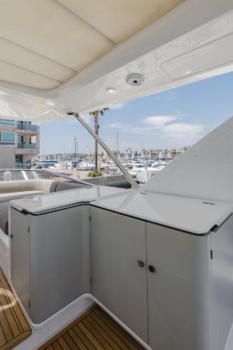 Slide: The Image of Azimut 60 Flybridge 2021 yacht interior with marina view, featuring sleek cabinetry and modern design. - 25