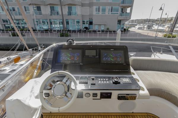 Slide: The Image of Azimut 60 Flybridge 2021 yacht helm with modern navigation displays and controls. - 28