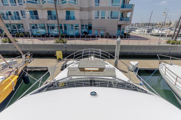 Slide: The Image of Azimut 60 Flybridge 2021 docked near modern waterfront building. - 29